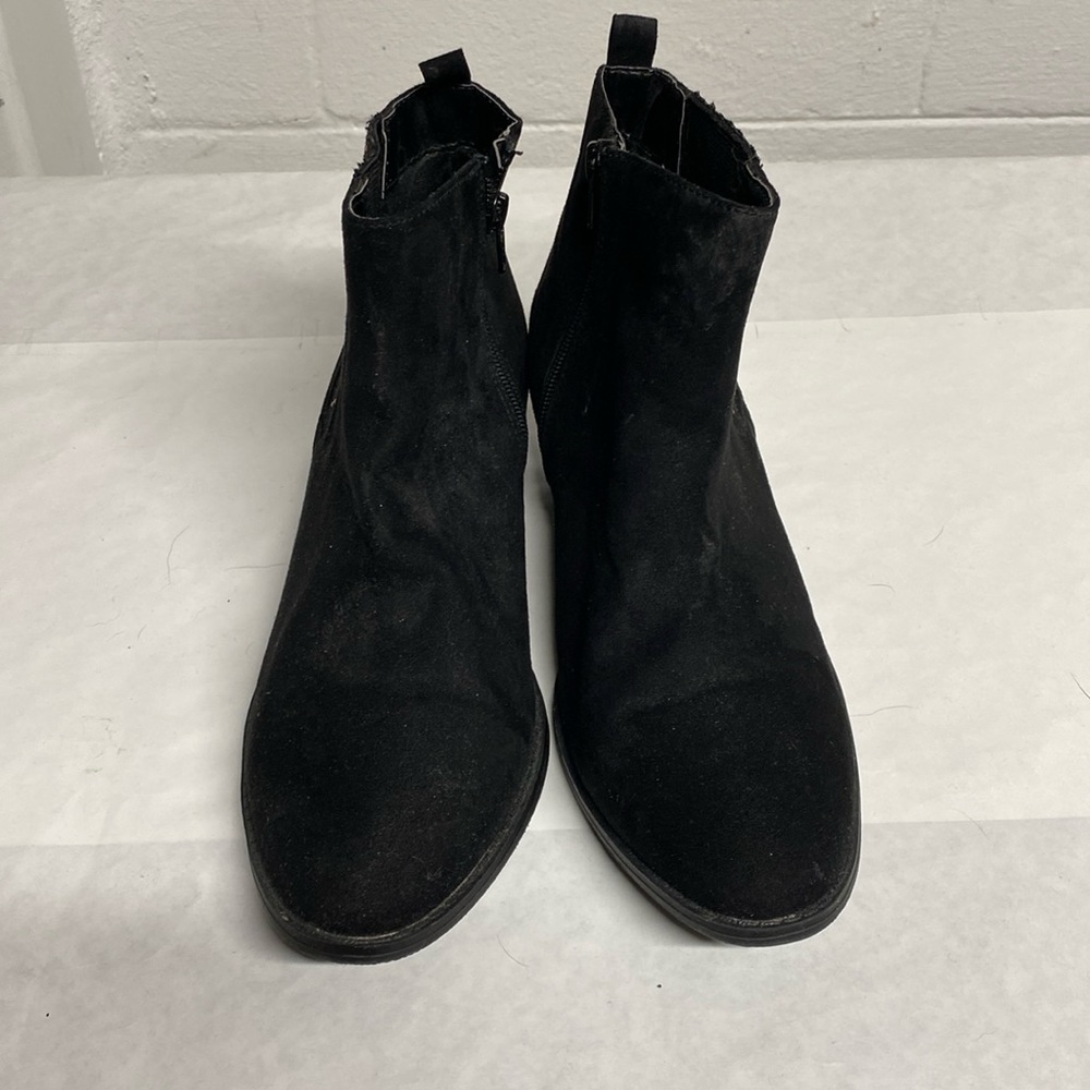 Women’s black suede ankle booties.